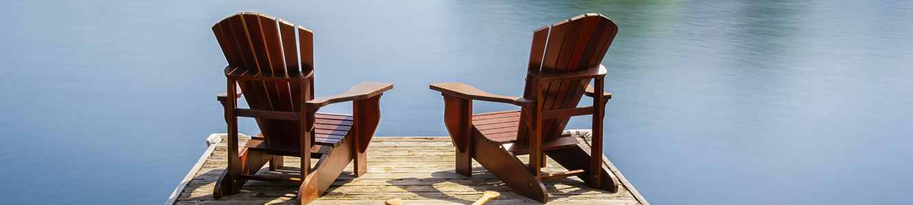 Vacation home deck with chairs on lake