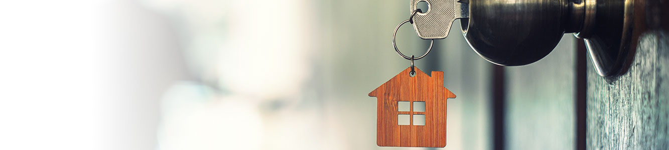 House key in the front door of a new home