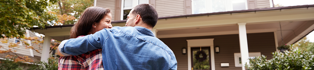 Couple walking together into their new home