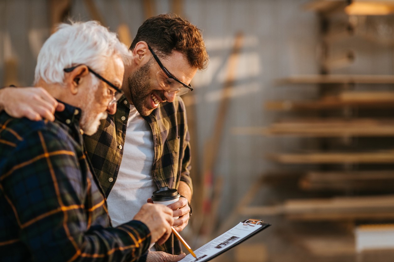 Two men looking over business transactions