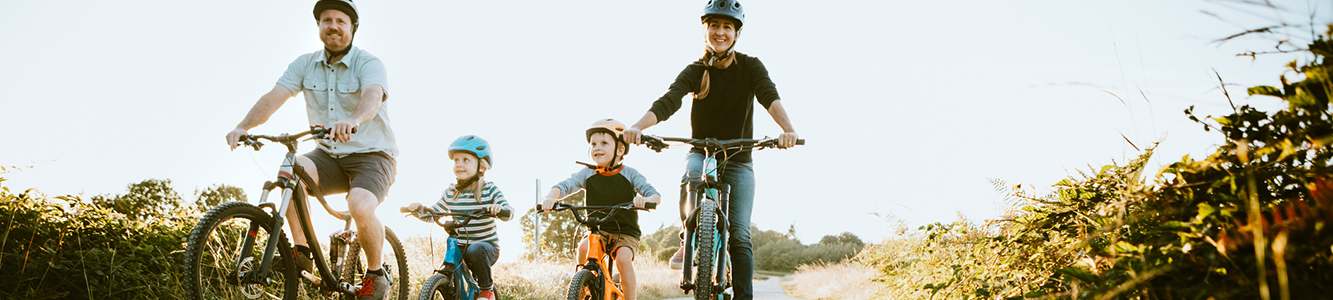 Parents riding bikes with their children